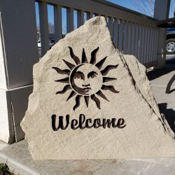 Engraved Stone Welcome Sign with Sun Emblem